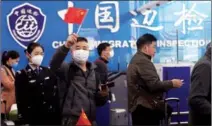  ?? CHEN RONGJIA / FOR CHINA DAILY ?? The national flag is waved by an arrival at Youyiguan Port, Guangxi Zhuang autonomous region.