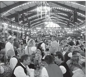  ?? Rick Steves’ Europe/RICK STEVES ?? With Germany’s best beers flowing by the liter at Oktoberfes­t, Bavarians are happy to toast with friendly foreigners.