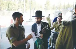  ?? (Tomer Neuberg/Flash90) ?? THE ENLISTMENT process for the Netzah Yehuda Battalion takes place at the Tal Hashomer military base.