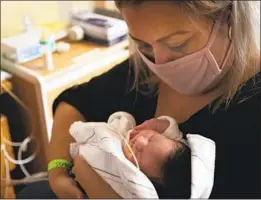  ?? Francine Orr Los Angeles Times ?? MONICA RAMIREZ, 38, with Emiliana. Ramirez contracted COVID- 19 while pregnant and was in a coma when the baby was delivered July 13 by caesarean.