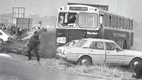  ?? Picture: Bongani Mnguni ?? Photograph­er Alf Kumalo takes evasive action during violent protests in Soweto on June 16 1980. The protests commemorat­ed the student uprising four years earlier.
