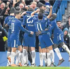  ??  ?? Willian celebrates with team-mates after putting Chelsea ahead against Barcelona at Stamford Bridge last night.