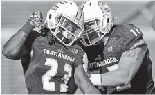  ?? STAFF PHOTO BY DOUG STRICKLAND ?? UTC running back Richardre Bagley, left, celebrates his touchdown with teammate Josh Cardiello against the VMI Keydets.