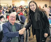  ??  ?? As per Mi’kmaw custom, Youth Chief Montana Marshall serves Shrove Tuesday dinner to Saqmaw Terry Paul.