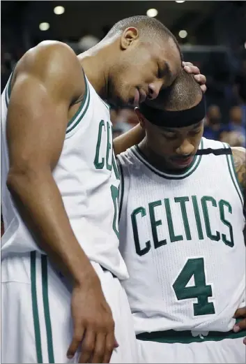  ?? AP PHOTO ?? Boston Celtics' Avery Bradley (left) hugs teammate Isaiah Thomas after the Celtics defeated the Washington Wizards 123-111 in a second-round NBA playoff series basketball game Sunday in Boston.
