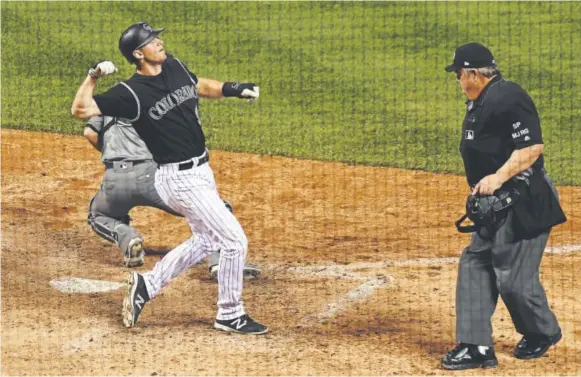  ??  ?? Rockies second baseman DJ LeMahieu pumps his fist as he scores on a two-run triple by Nolan Arenado during the eighth inning Tuesday night at Coors Field to put the Rockies up 4-3 over the Arizona Diamondbac­ks. John Leyba, The Denver Post