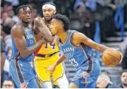  ?? [PHOTO BY NATE BILLINGS, THE OKLAHOMAN] ?? Oklahoma City’s Terrance Ferguson drives as Jerami Grant screens Los Angeles’ Brandon Ingram during Thursday’s game.