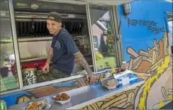  ?? Steve Mellon/Post-Gazette ?? Matt Christie, of the South Side, chats with customers at Streets on the Fly food truck in Ben Avon on Aug. 20.