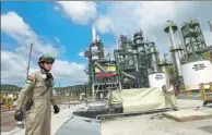  ?? REUTERS ?? A worker monitors operations at a refurbishe­d oil refinery in Esmeraldas, Ecuador, South America, on Dec 17, 2015.