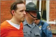  ??  ?? Eric Frein is escorted by police out the Pike County Courthouse after his arraignmen­t Friday in Milford, Pa.