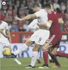  ??  ?? 1 Gary Mackay-steven slots home the penalty given after Sam Cosgrove was fouled to put Aberdeen 1-0 ahead.
2 Burnley striker Sam Vokes equalises with ten minutes to go despite the attentions of Scott Mckenna.
3 The Dons fans pay tribute to club...