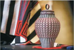  ??  ?? Jeremy Frey’s Best of Class winner in Basketry and Nellie Begay’s Best of Class entry in Textiles are displayed Friday at the 97th annual Santa Fe Indian Market awards presentati­on.