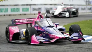  ?? The Associated Press ?? ■ Alexander Rossi (27) races during the IndyCar Detroit Grand Prix race on Belle Isle in Detroit Sunday.