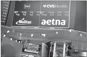  ?? Bloomberg News/MICHAEL NAGLE ?? A monitor displays CVS Health Corp. and Aetna Inc. signs Monday on the floor of the New York Stock Exchange.