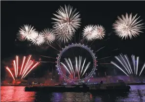  ?? TOLGA AKMEN / AGENCE FRANCE-PRESSE ?? Fireworks explode around the London Eye during New Year’s celebratio­ns in central London just after midnight on Monday.