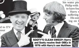  ?? ?? SOOTY’S CLEAN SWEEP: Harry and Sooty receive their OBES in 1976 with Harry’s son Matthew