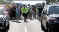  ?? DAVID ANGELL — THE MACOMB DAILY ?? Protesters head east along M-59/Hall Road in Macomb County, escorted by police, to rally against incidents of police brutality and racial discrimina­tion following the May 25 death of George Floyd in Minneapoli­s.
