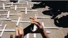  ?? PICTURE: CHRIS COLLINGRID­GE ?? SENSE OF LOSS: Families of the Life Esidimeni victims placed wooden crosses outside the Health Department in Joburg.