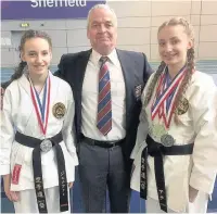  ??  ?? ●●Warriors’ Jennifer Forbes, left, and Anna Forbes, right, with Sensei Damien McLaughlin