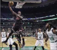  ?? CHARLES KRUPA — THE ASSOCIATED PRESS ?? Chicago Bulls forward Jimmy Butler (21) drives to the basket through the Boston Celtics defense in the first quarter of a first-round NBA playoff basketball game in Boston, Tuesday.