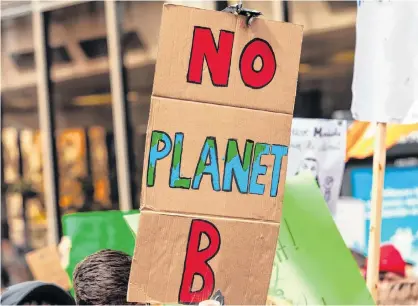  ?? — 123RF STOCK PHOTO ?? A cardboard poster is seen close-up, saying there is no planet b, held by an eco-activist during a demonstrat­ion on a street in Montreal. According to new research, the majority of Canadians in all but three ridings across the country believe their province has already felt the effects of climate change.