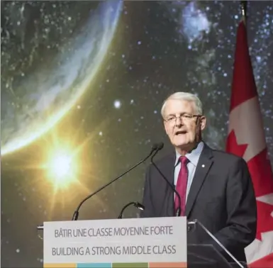  ?? RYAN REMIORZ, THE CANADIAN PRESS ?? Minister of Transport and former astronaut Marc Garneau announces new funding at the Canadian Space Agency headquarte­rs, Thursday.