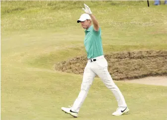  ?? PETER MORRISON, AP ?? Rory McIlroy of Northern Ireland salutes the crowd after holing out of the bunker on the 10th hole during the third round of the British Open at St. Andrews, Scotland, on Saturday.