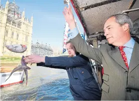  ?? Picture: TOBY MELVILLE/REUTERS ?? Former Ukip leader Nigel Farage dumps fish in the Thames yesterday