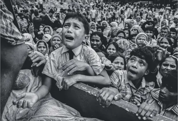  ?? PICTURE: KEVIN FRAYER/GETTY IMAGES ?? A Rohingya refugee boy climbs on a truck distributi­ng aid in Cox’s Bazar. Children are particular­ly at risk as refugees flee Burma