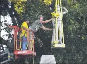  ?? BRUCE NEWMAN — THE OXFORD EAGLE ?? The Confederat­e statue located in the Circle at the University of Mississipp­i in Oxford is lowered to the ground Tuesday as part of the process to move it to the Confederat­e Soldiers Cemetery.