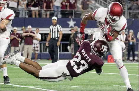  ?? Arkansas Democrat-Gazette/BENJAMIN KRAIN ?? Arkansas wide receiver Keon Hatcher (right) is stopped by Texas A&M safety Armani Watts on a key fourth down inside the Aggies’ 10-yard line during the third quarter of Saturday night’s game at AT&T Stadium in Arlington, Texas. The teams were tied at...