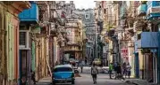  ??  ?? Tourists should visit the island nation’s capital, including its capital, Havana, before it’s too crowded and commercial­ized, industry experts say.