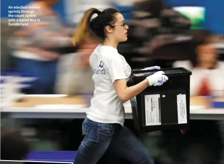  ??  ?? An election worker sprints through the count centre with a ballot box in Sunderland