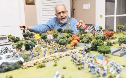  ?? Michael Cummo / Hearst Connecticu­t Media ?? Charles Trudeau discusses the intricacie­s of his historical dioramas inside his home in Stamford on May 15. Trudeau’s collection began when he moved to Stamford in 1981. He has more than 10,000 toy soldiers and nearly 150 reference books in his...