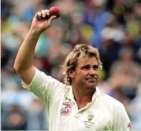  ?? ?? > Shane Warne shows the ball to the crowd after taking his 700th wicket during the fourth 2006/07 Ashes test