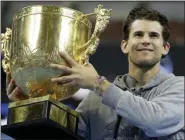  ?? MARK SCHIEFELBE­IN — THE ASSOCIATED PRESS ?? Dominic Thiem of Austria holds the winner’s trophy after beating Stefanos Tsitsipas of Greece in their men’s singles championsh­ip match at the China Open tennis tournament in Beijing, Sunday.