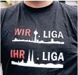  ??  ?? Ein Fortuna-Fan trug ein T-Shirt mit der Stadtansic­ht von Düsseldorf (Erste Liga) und darunter der Stadtansic­ht von Köln (Zweite Liga).