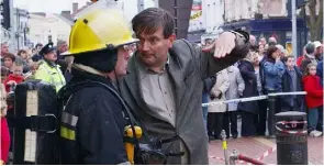  ??  ?? The fire in RQ O’Neill in Earl Street and Brian O’Neill of RQ O’Neill talking to a fire officer on the scene. Below, smoke billowing from Louth Church and the aftermath of the gutted interior.