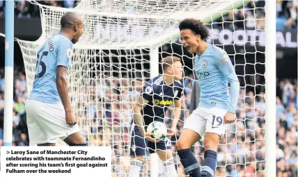  ??  ?? > Leroy Sane of Manchester City celebrates with teammate Fernandinh­o after scoring his team’s first goal against Fulham over the weekend Burnley (H), September 30th
