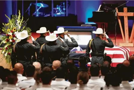  ?? Photos by Melissa Phillip / Staff photograph­er ?? Harris County Sheriff ’s Honor Guard members salute the casket of Deputy Omar Diaz during a funeral service for Diaz on Thursday at Champions Forest Baptist Church in Jersey Village. Diaz died of a pulmonary embolism Saturday while on duty.