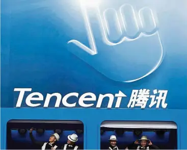  ??  ?? Much to celebrate: Dancers perform underneath the logo of Tencent at a conference in Beijing in 2014. The company posted a faster-than-anticipate­d 52% rise in revenue to 40.4 billion yuan (US$5.9bil) in the third quarter. — Reuters