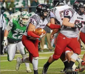  ?? GREGG SLABODA — TRENTONIAN PHOTO ?? Allentown’s Joe Mannino, left, carries the ball against Brick Twp. in the Central Jersey Group IV section final at Rutgers University’s High Point Solutions Stadium.