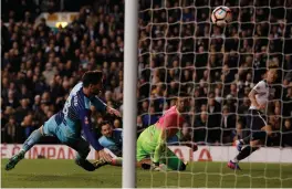  ?? (Reuters) ?? SON HEUNG-MIN (right) scores Tottenham Hotspur’s fourth goal as Wycombe Wanderers’ Joe Jacobson (left) attempts to block it in their 4-3 FA Cup fourth-round thriller in London yesterday.