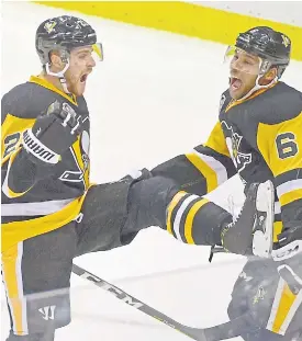  ??  ?? Penguins left wing Scott Wilson, left, celebrates his goal against the Sharks.