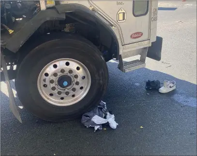  ?? MIKE WOLCOTT — ENTERPRISE-RECORD ?? Belongings of a cyclist involved in a crash with a garbage truck litter the pavement Tuesday at Nord and West Sacramento avenues in Chico.