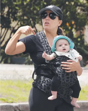  ??  ?? Eva Longoria goes for a walk with her baby boy Santiago after arriving on the Gold Coast.