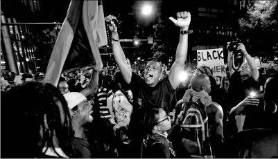  ?? JASON MICZEK / REUTERS ?? A man shouts at the intersecti­on of Trade and College Streets during a protest against the police shooting of Keith Scott, in Charlotte, North Carolina, US on Thursday.