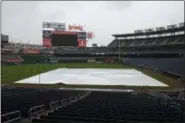  ?? NICK WASS — THE ASSOCIATED PRESS ?? The tarp lies on the baseball field, Friday, May 12, 2017, in Washington. The baseball game between the Washington Nationals and the Philadelph­ia Phillies was postponed due to inclement weather.