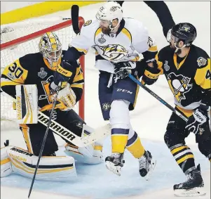  ?? AP PHOTO ?? Pittsburgh Penguins’ Justin Schultz (4) checks Nashville Predators’ Harry Zolnierczy­k (26) as he crosses the crease in front of Penguins goalie Matt Murray (30) during the third period in Game 5 of the NHL hockey Stanley Cup Final, Thursday, in Pittsburgh.