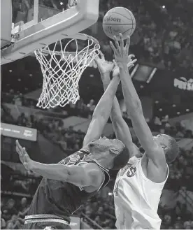  ?? Kin Man Hui/staff photograph­er ?? Spurs center Charles Bassey, left, suffered a season-ending non-displaced fracture of his left patella in Tuesday’s win over the Orlando Magic.